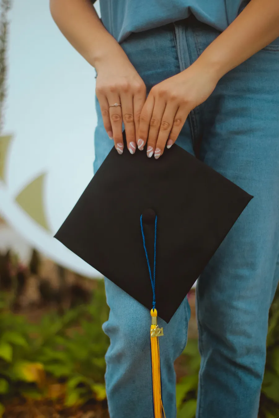 Person holding graduation cap